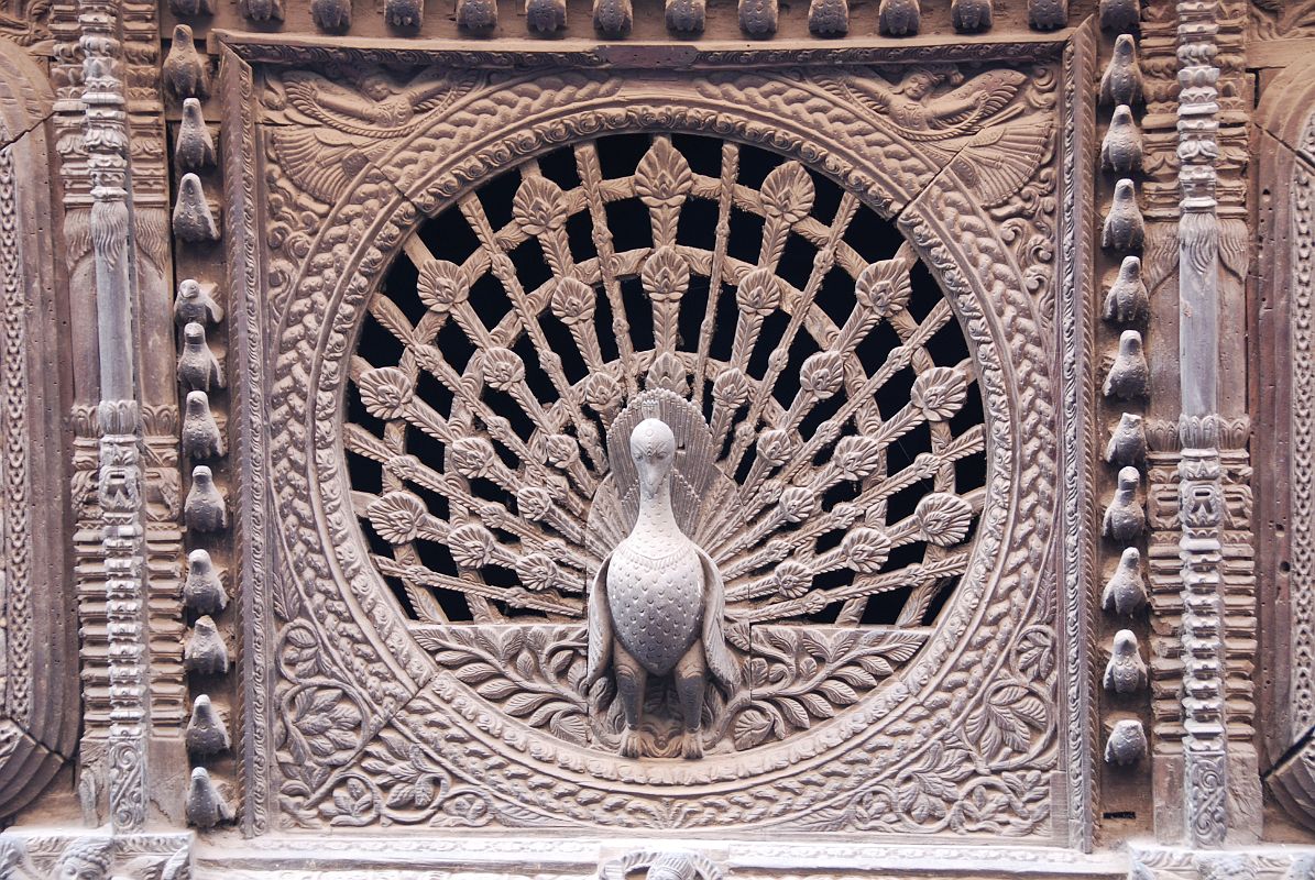 Kathmandu Bhaktapur 09 Peacock Window The 15C peacock window near Pujari Math in Bhaktapur is reputed to be the finest carved window in the Kathmandu Valley.  I went to the upper floor window of the shop opposite to get a better photo.